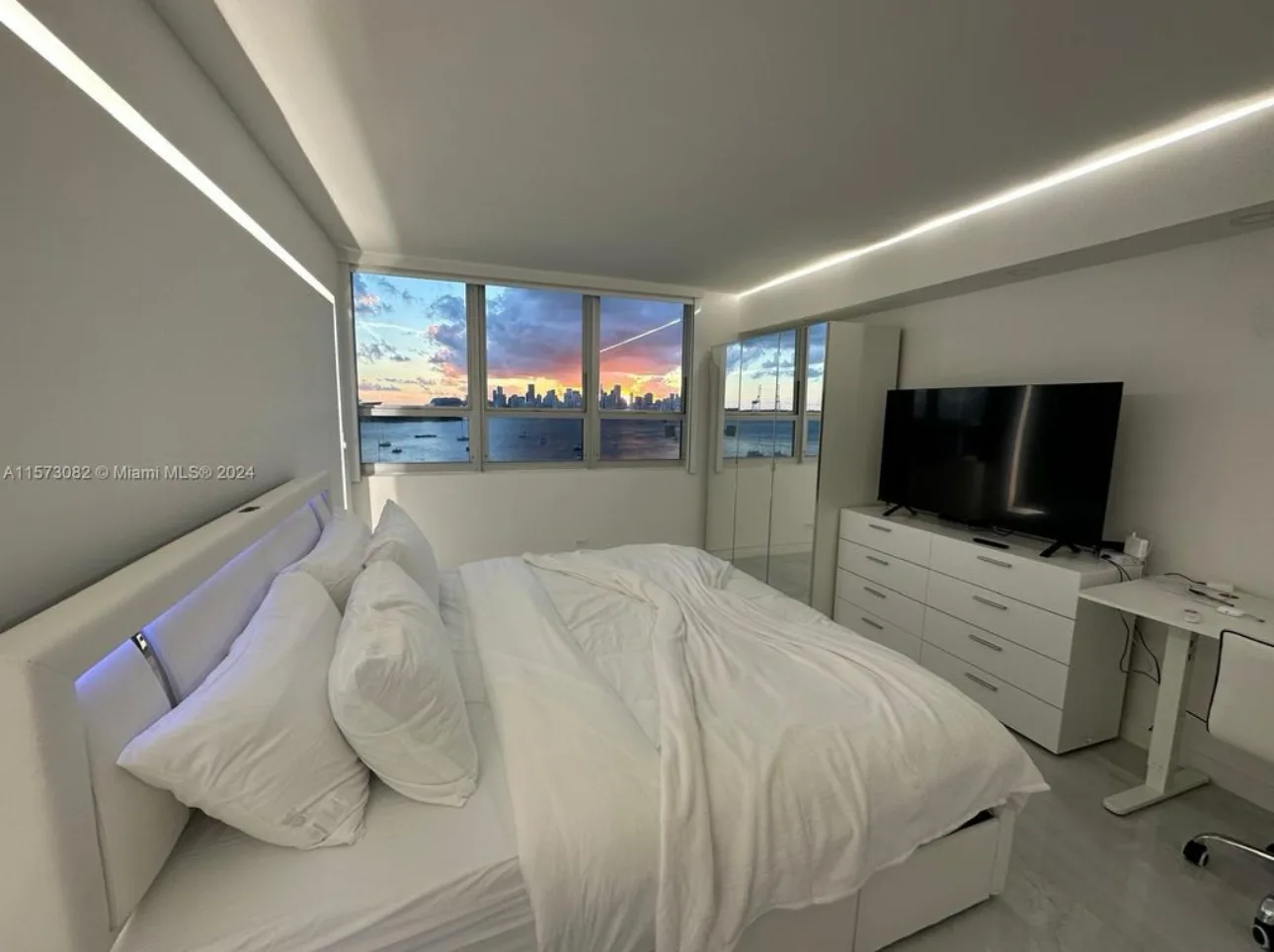 Bedroom with LED headboard and Miami skyline sunset